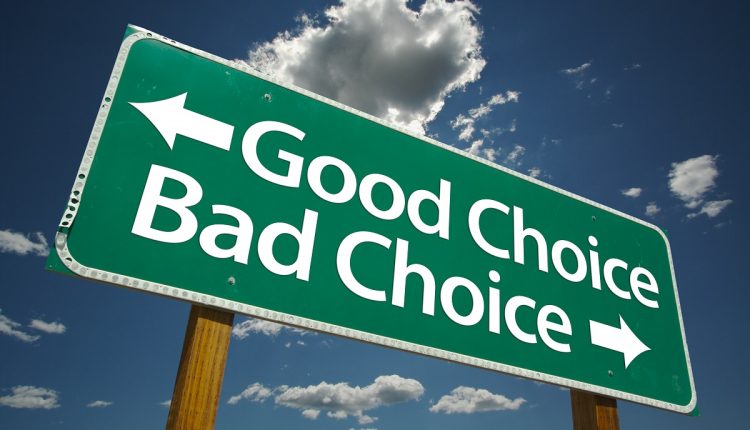 Good Choice, Bad Choice Road Sign with blue sky and clouds.