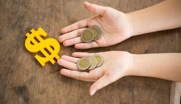 coins on hands child and The yellow dollar symbol on table