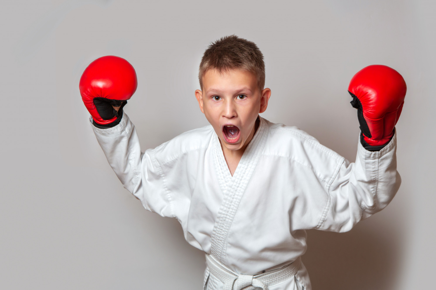 teenager-white-kimono-gloves-hand-hand-combat-gray-doing-sports