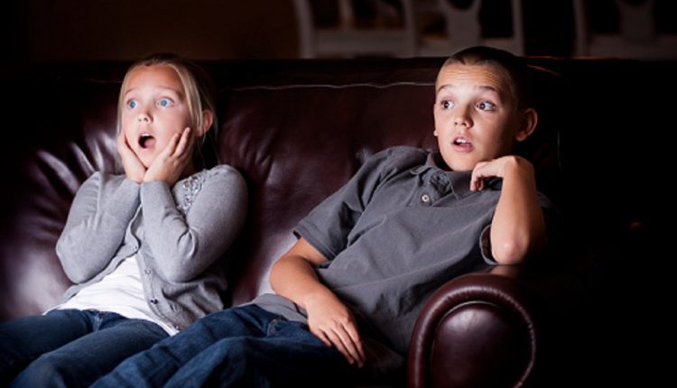 Two Children watching Shocking Television Programming at home without parents