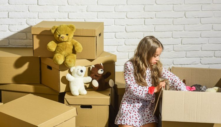 Where Excellence and Convenience Meet. playing into new home. new apartment. happy child cardboard box. purchase of new habitation. Cardboard boxes – moving to new house. happy little girl with toy