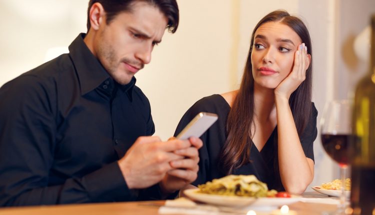 Unhappy Woman Bored On Date, Man Using Phone
