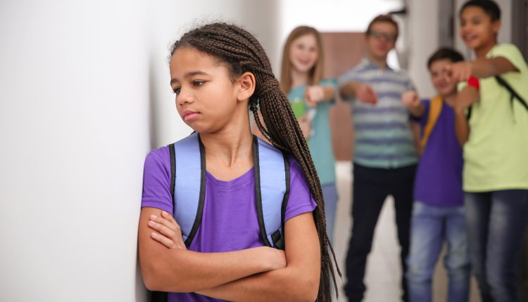 Sad African American girl indoors. Bullying in school