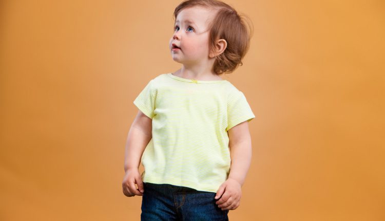 one-cute-baby-girl-orange-background