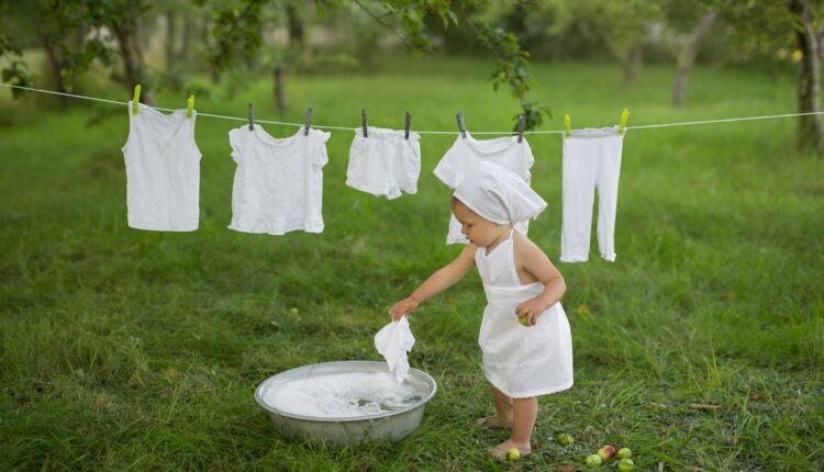child-cheerfully-launderes-his-clothes-basin-spray-water-foam-from-washing-clothes