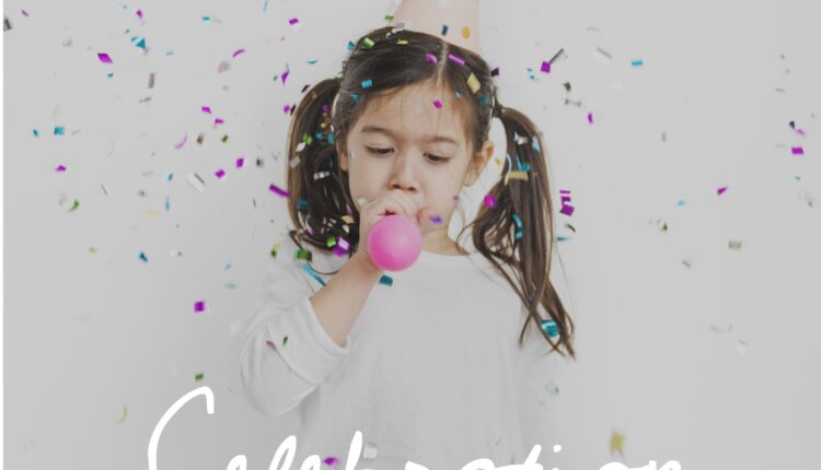 Young girl enjoying blowing balloon party celebration